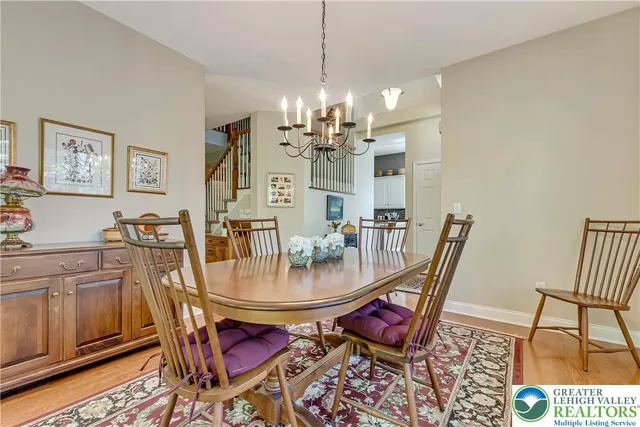 a kitchen with stainless steel appliances granite countertop a stove a sink dishwasher and a refrigerator with wooden floor