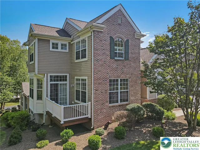 a view of a house with a yard and tree s