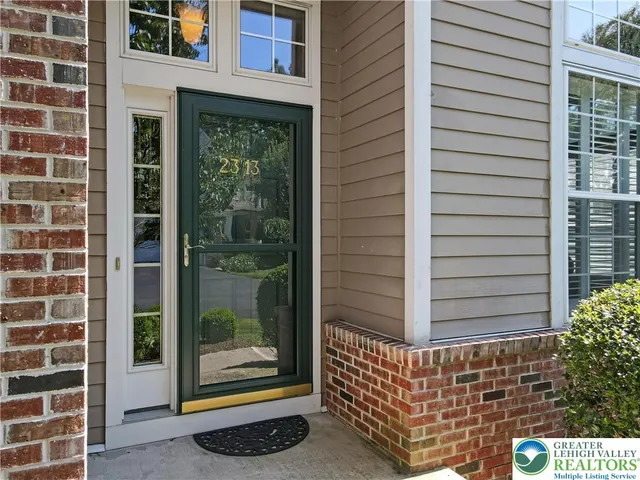 a view of a hallway and a dining room with wooden floor