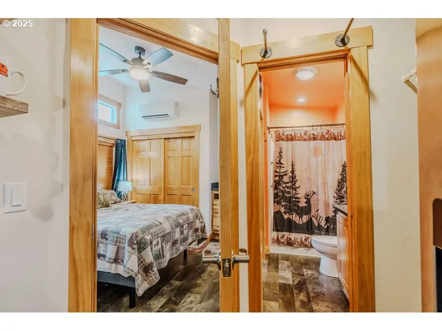 a view of a bedroom with a large window and front door