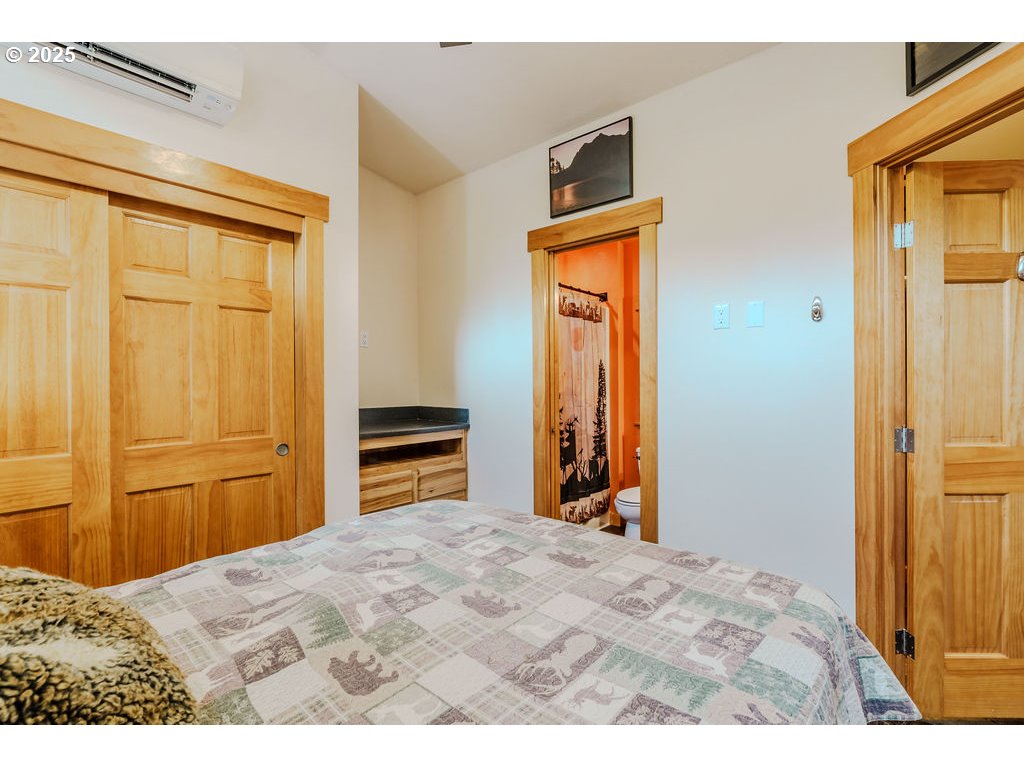 65000 Highway 26, Unit WFB50 Welches, OR 97067 - Photo 17 of 30 a bedroom with a bed and a chandelier