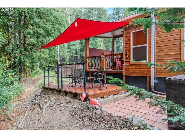 a view of a house with backyard and sitting area
