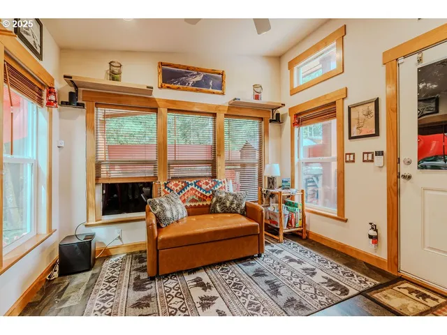 a living room with furniture rug and wooden floor