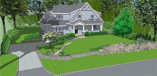 a view of a white house with a big yard plants and large trees