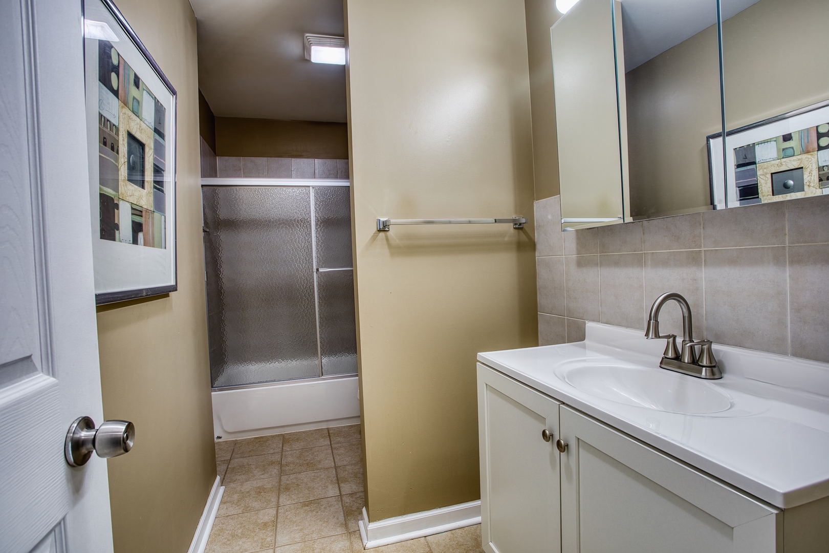 805 Stowell Avenue Streamwood, IL 60107 - Photo 16 of 30 a bathroom with a sink a mirror and shower