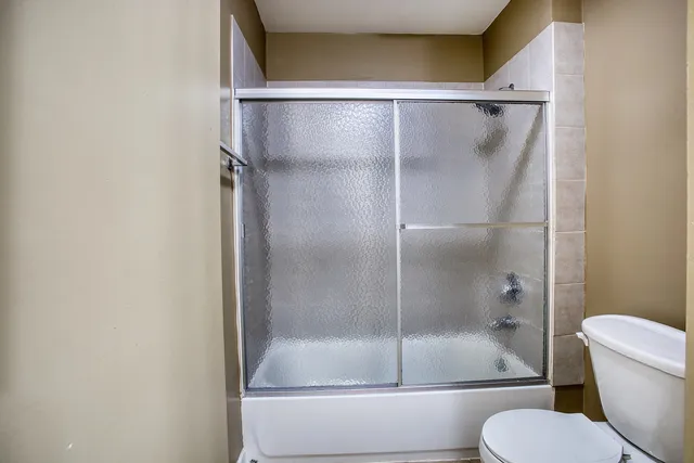 a bathroom with a shower and toilet