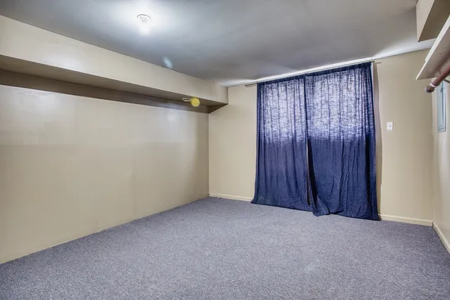 a view of an empty room with a wooden door