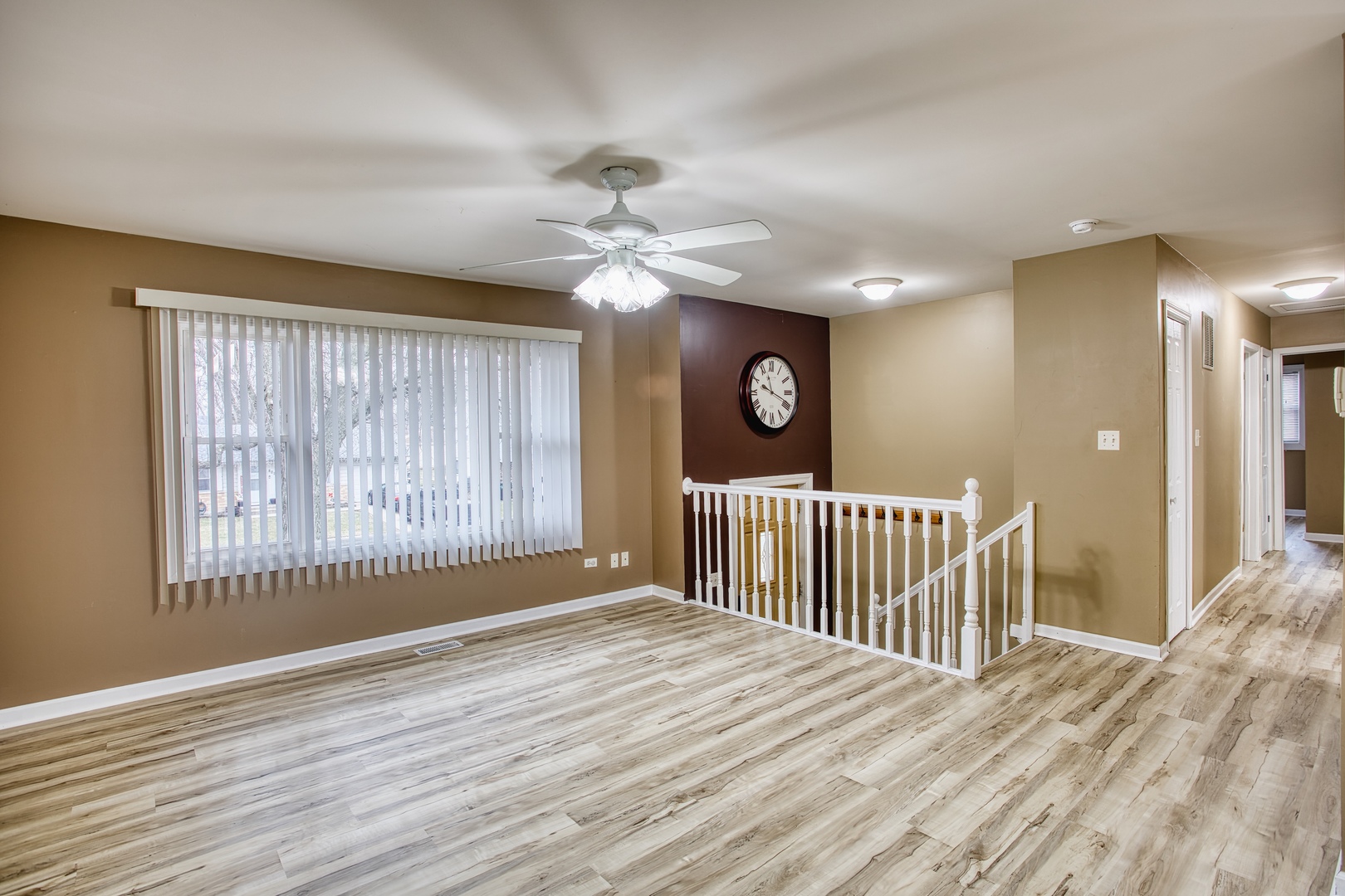 805 Stowell Avenue Streamwood, IL 60107 - Photo 4 of 30 an empty room with wooden floor fan and windows