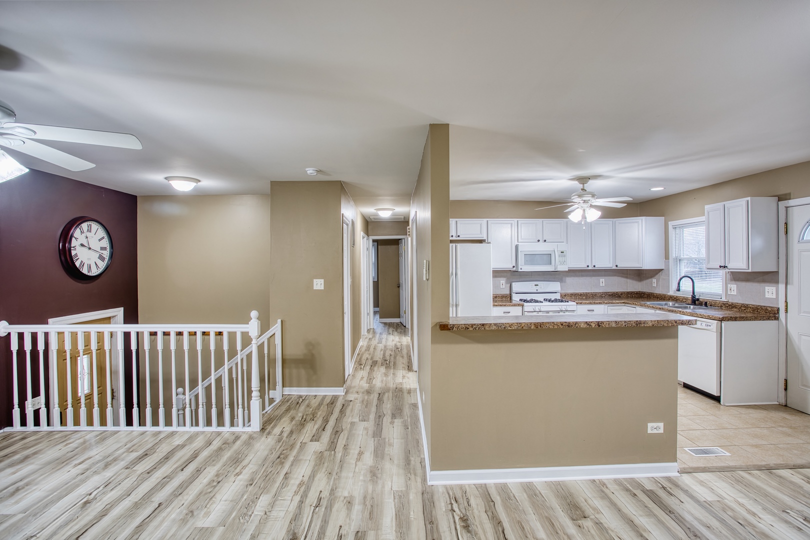 805 Stowell Avenue Streamwood, IL 60107 - Photo 5 of 30 a kitchen with kitchen island granite countertop a refrigerator and a sink