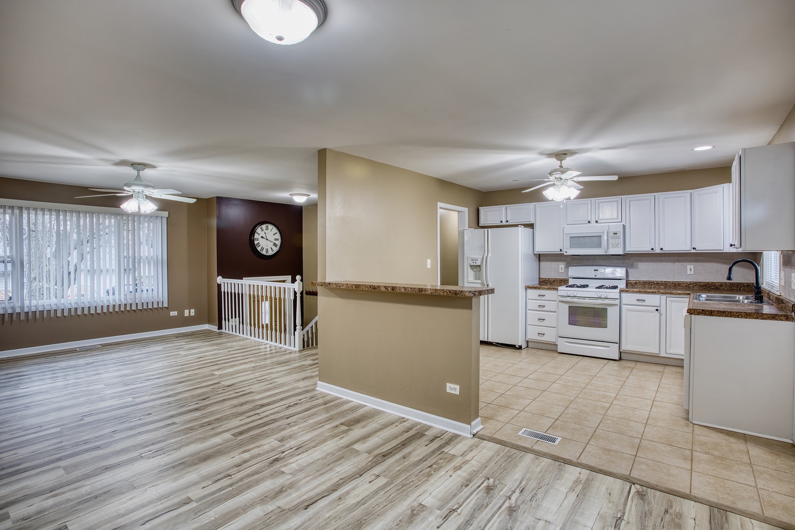 805 Stowell Avenue Streamwood, IL 60107 - Photo 6 of 30 a kitchen with stainless steel appliances granite countertop a refrigerator sink and cabinets