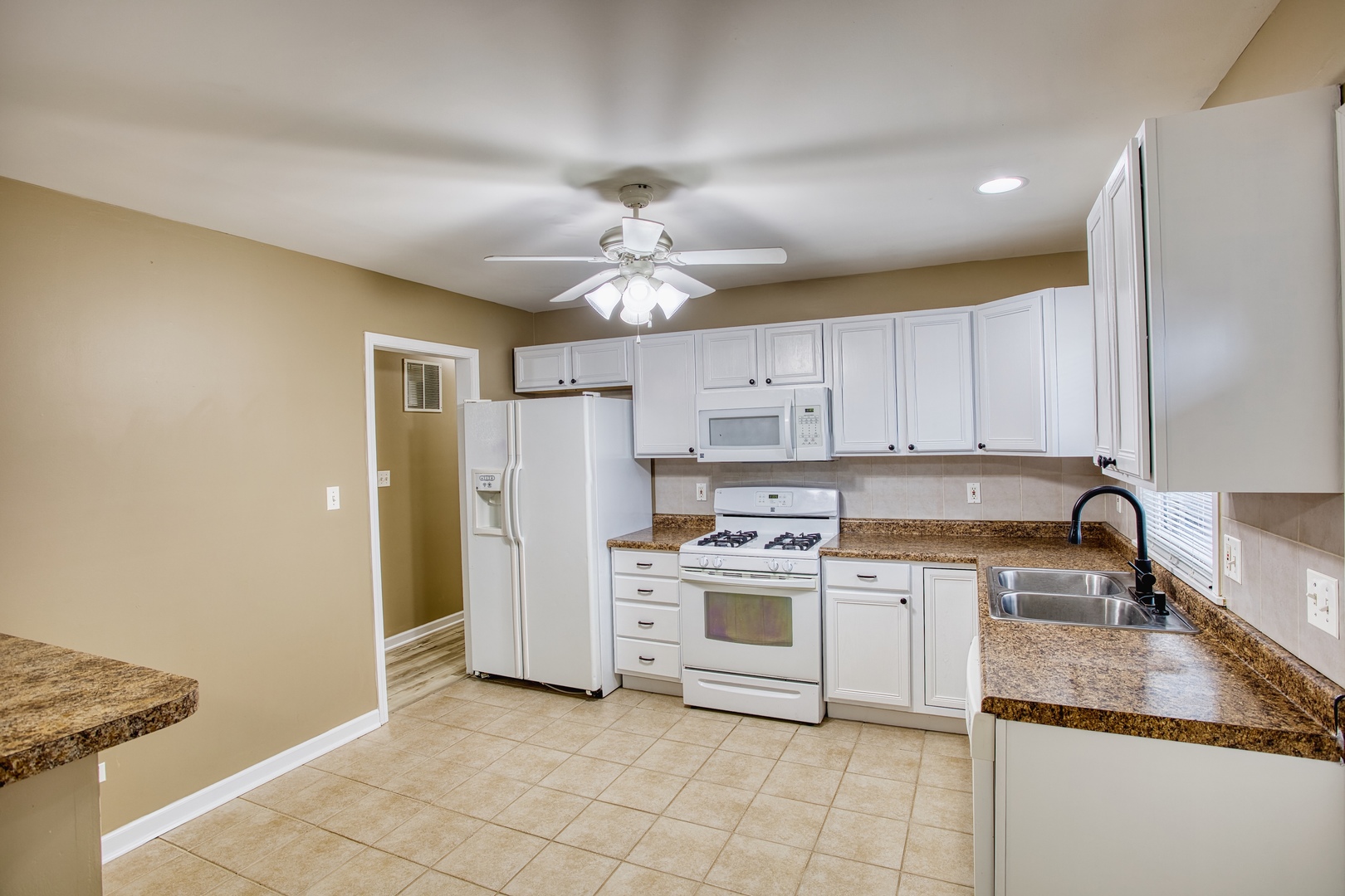 805 Stowell Avenue Streamwood, IL 60107 - Photo 7 of 30 a kitchen with a stove a sink and a refrigerator