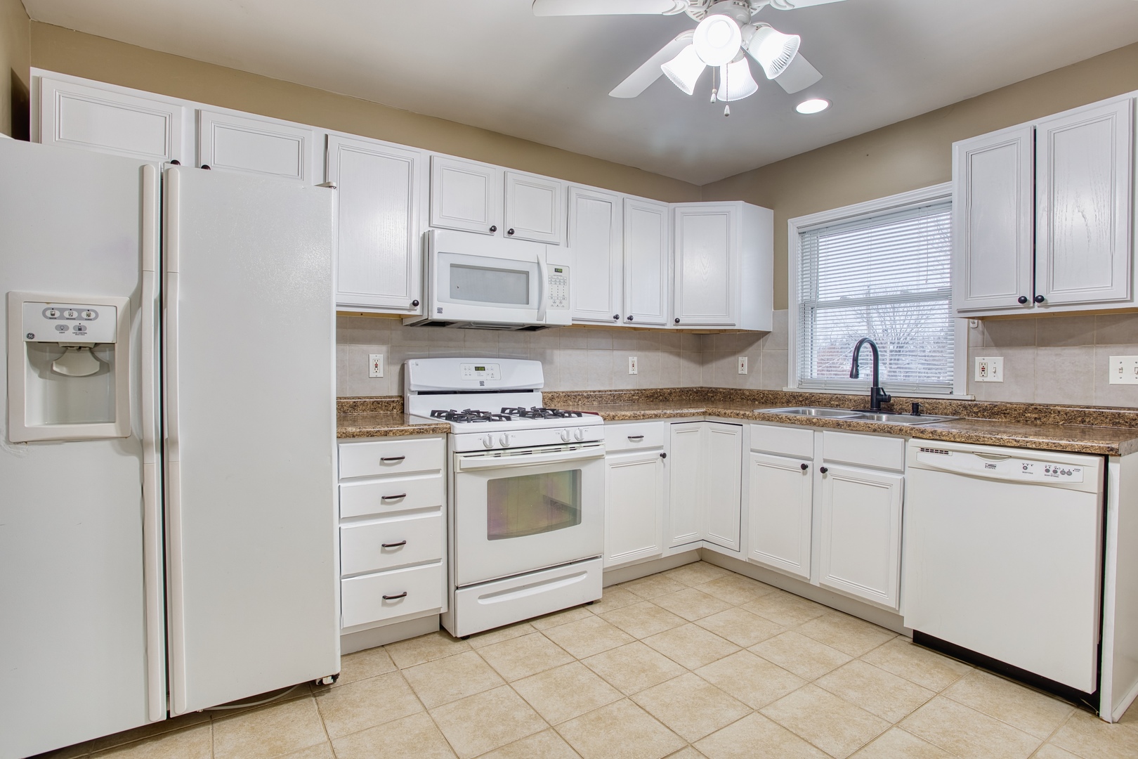 805 Stowell Avenue Streamwood, IL 60107 - Photo 8 of 30 a kitchen with granite countertop cabinets and white stainless steel appliances