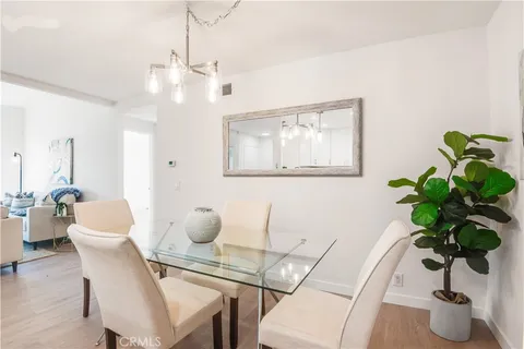 a dining room with furniture and potted plant