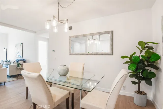 a dining room with furniture and potted plant