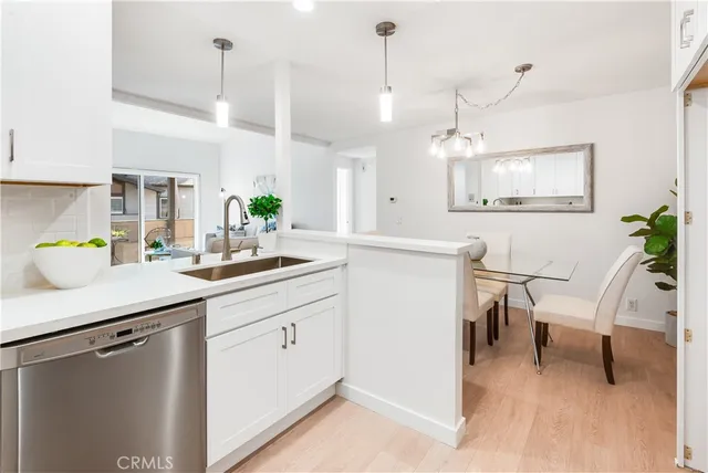 a kitchen with a sink a counter space and appliances