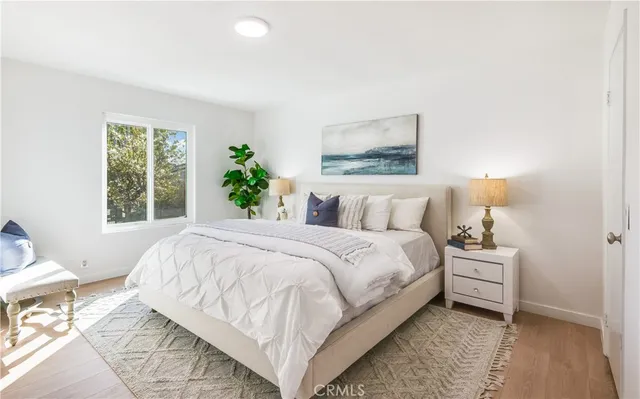 a bedroom with a bed and a painting on the wall