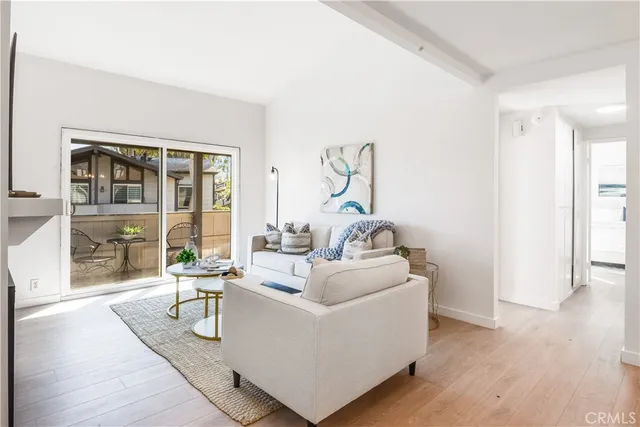 a living room with furniture and a floor to ceiling window