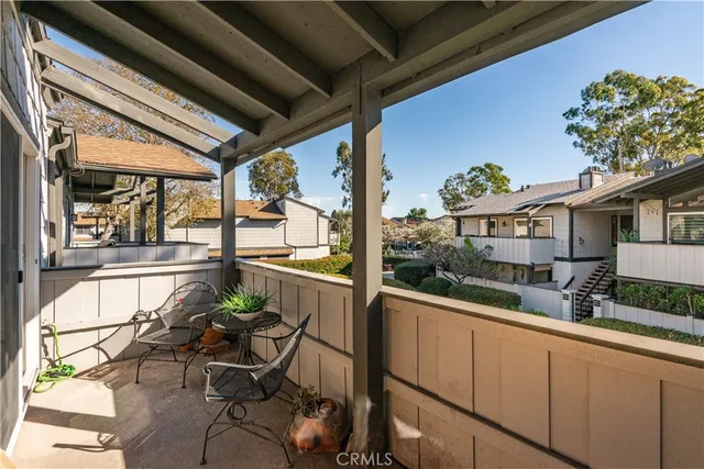 a view of a porch with chairs and potted plants