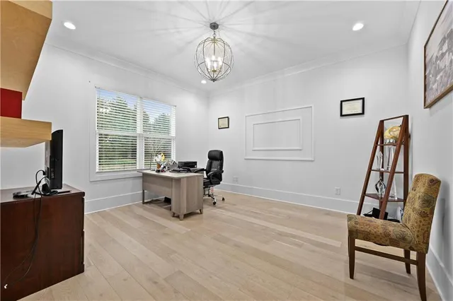 a bedroom with a bed couch and a large window