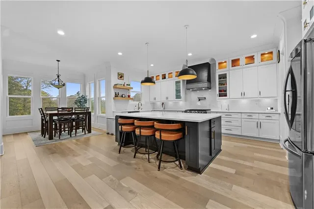 a kitchen with stainless steel appliances kitchen island granite countertop a sink and cabinets