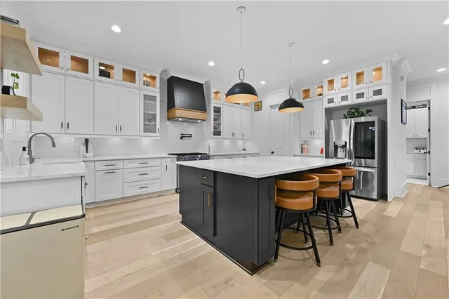 a kitchen with stainless steel appliances granite countertop a stove and a sink