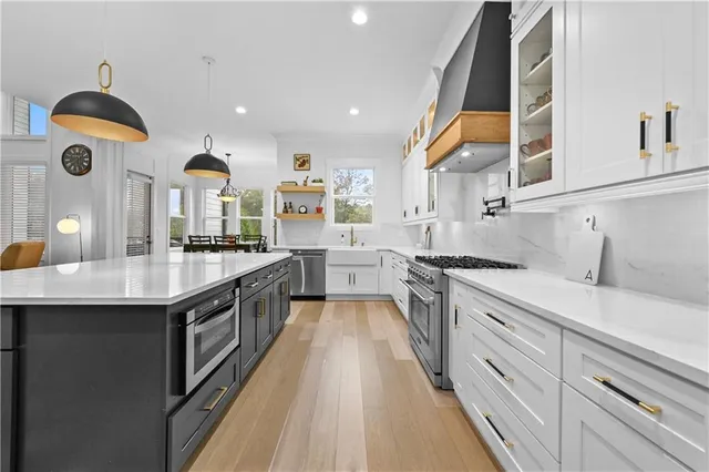 a dining room with furniture a chandelier and wooden floor