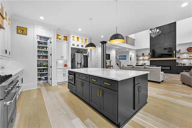 a balcony with wooden floor table and chairs