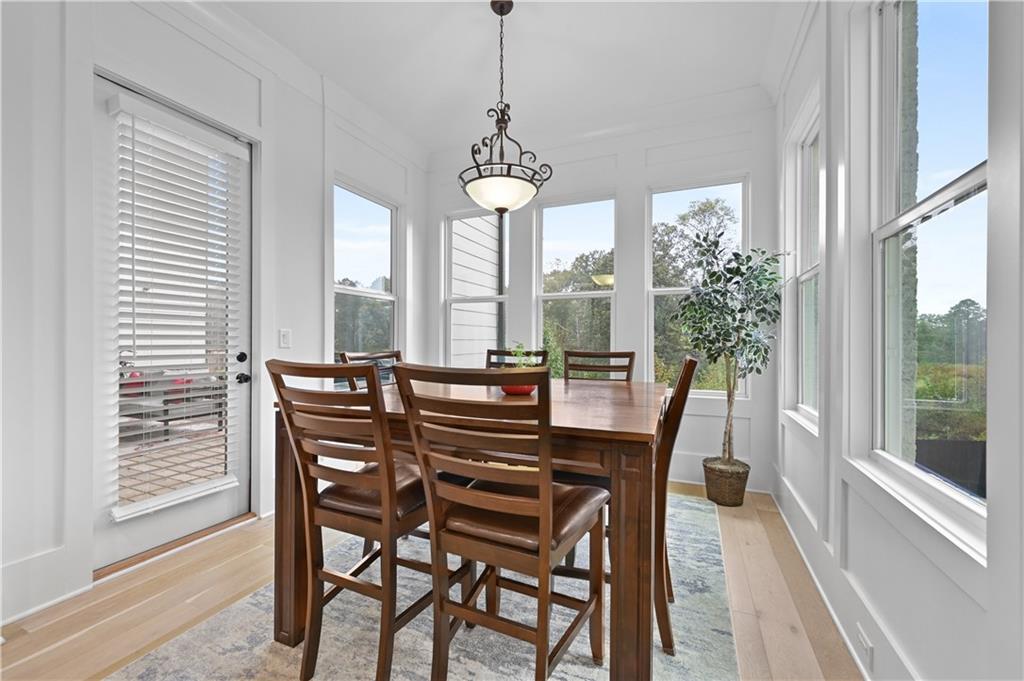 2550 Kilgore Road Buford, GA 30519 - Photo 22 of 64 a dining room with furniture a chandelier and wooden floor