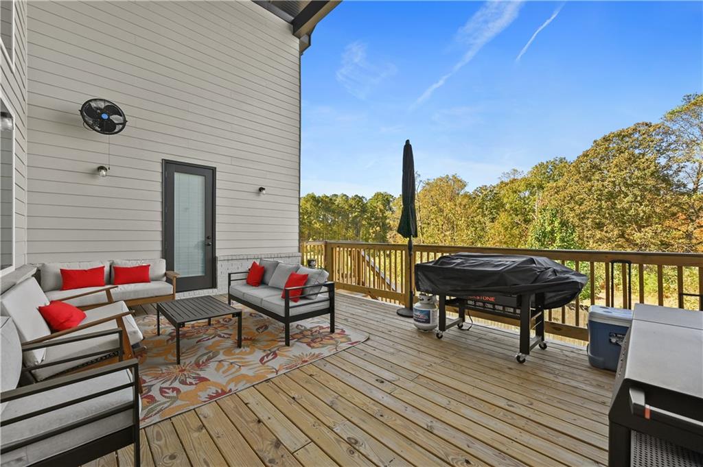 2550 Kilgore Road Buford, GA 30519 - Photo 24 of 64 a balcony with wooden floor table and chairs
