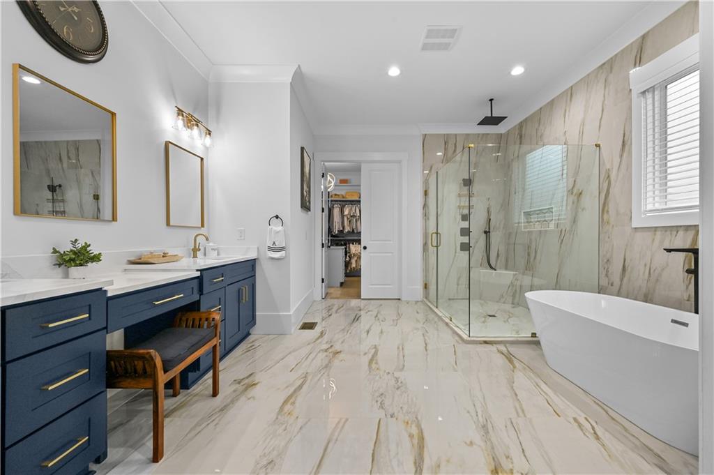 2550 Kilgore Road Buford, GA 30519 - Photo 32 of 64 a spacious bathroom with a double vanity sink a large mirror and a bathtub
