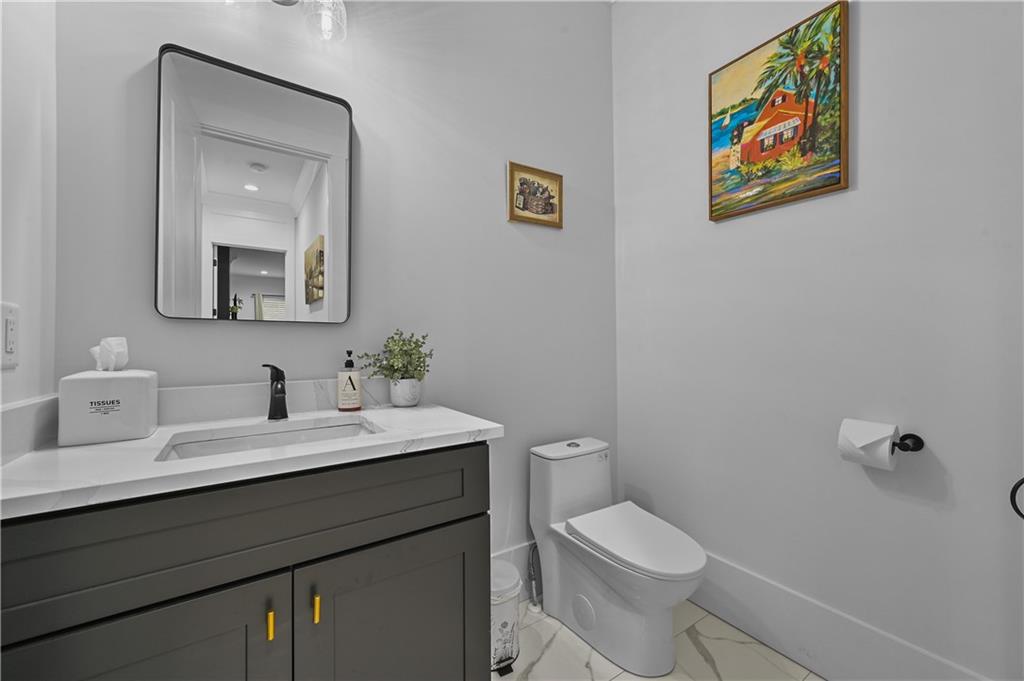 2550 Kilgore Road Buford, GA 30519 - Photo 36 of 64 a bathroom with a toilet a sink and mirror