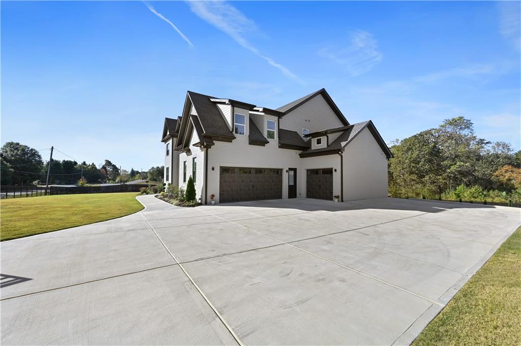 2550 Kilgore Road Buford, GA 30519 - Photo 4 of 64 a front view of a house with swimming pool and yard