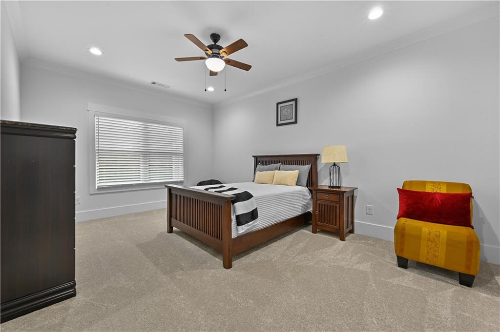 2550 Kilgore Road Buford, GA 30519 - Photo 42 of 64 a spacious bedroom with a bed and a chandelier