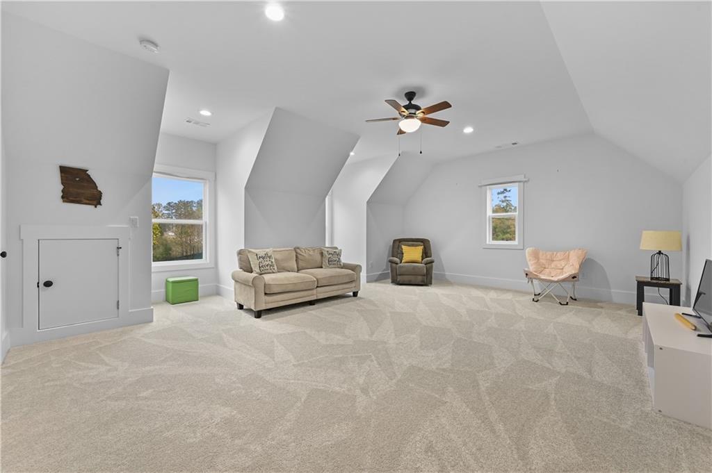 2550 Kilgore Road Buford, GA 30519 - Photo 44 of 64 a living room with furniture and a chandelier