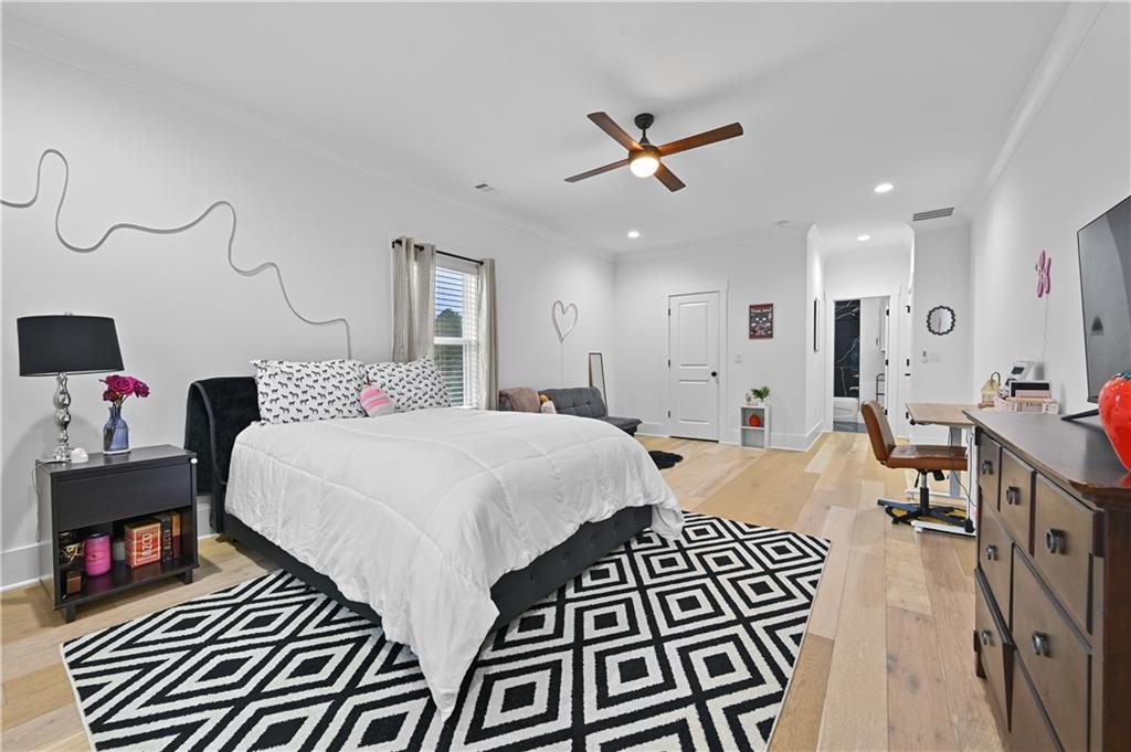 2550 Kilgore Road Buford, GA 30519 - Photo 50 of 64 a bedroom with a bed and a chandelier