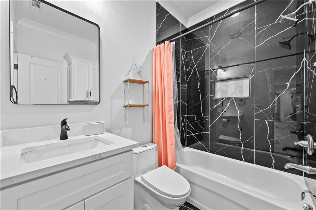 2550 Kilgore Road Buford, GA 30519 - Photo 51 of 64 a bathroom with a sink toilet and shower