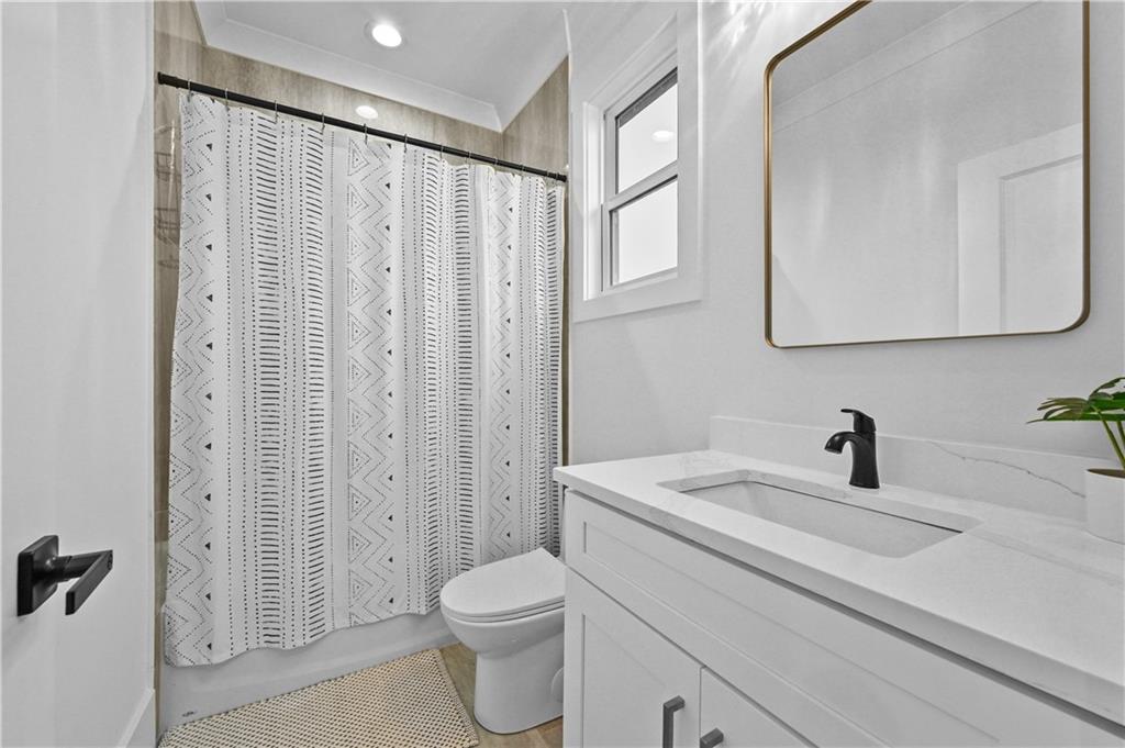 2550 Kilgore Road Buford, GA 30519 - Photo 54 of 64 a bathroom with a sink a toilet and shower