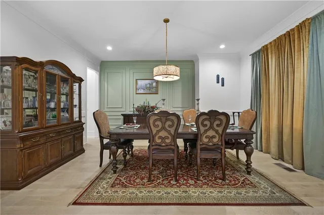 a dining room with wooden floor and a chandelier