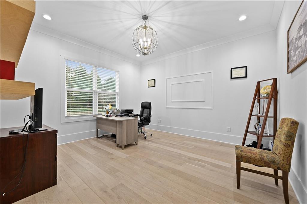 2550 Kilgore Road Buford, GA 30519 - Photo 10 of 64 a dining room with wooden floor and a chandelier