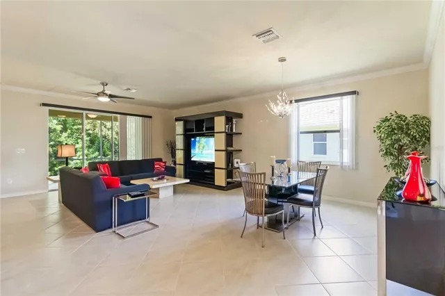a living room with stainless steel appliances granite countertop furniture a fireplace a rug and a window
