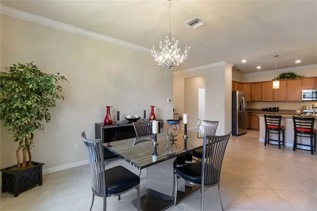 a kitchen with a refrigerator and a dining table