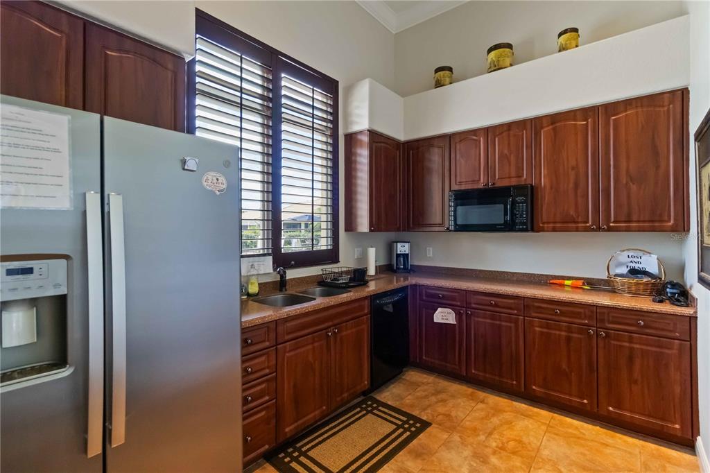 1480 Mossy Oak Drive North Port, FL 34287 - Photo 20 of 39 a kitchen with stainless steel appliances sink a microwave and cabinets