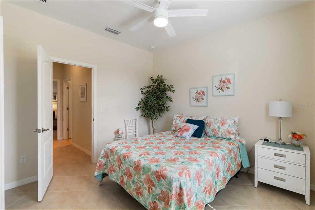 1480 Mossy Oak Drive North Port, FL 34287 - Photo 22 of 39 a bedroom with a bed and a chandelier