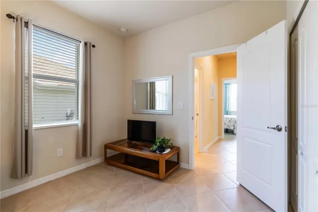 a bedroom with a bed and a dresser with mirror