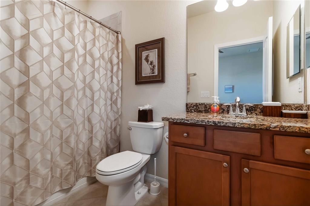 1480 Mossy Oak Drive North Port, FL 34287 - Photo 30 of 39 a bathroom with a granite countertop toilet sink and mirror