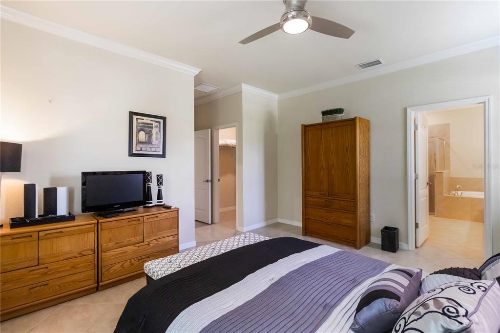 1480 Mossy Oak Drive North Port, FL 34287 - Photo 31 of 39 a bedroom with a bed and flat screen tv