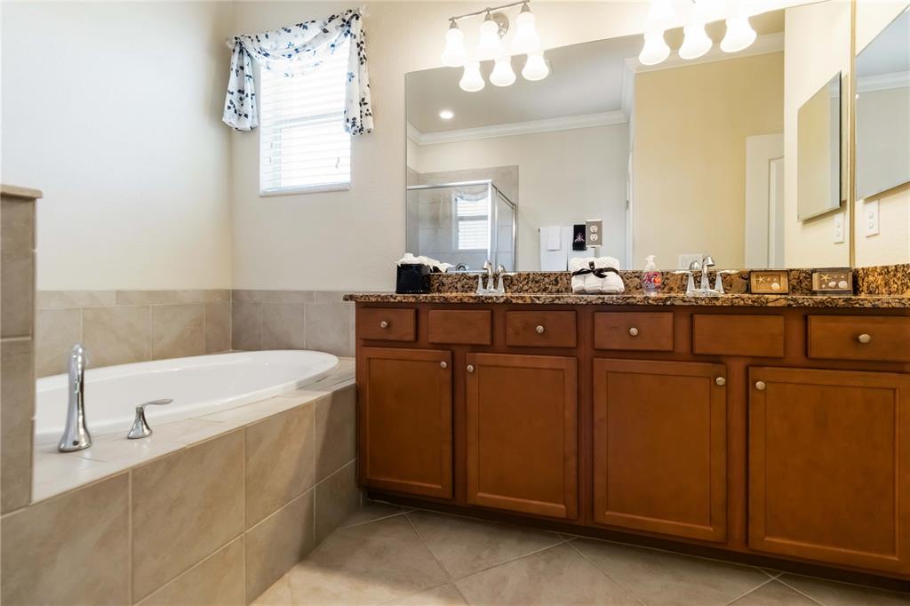 1480 Mossy Oak Drive North Port, FL 34287 - Photo 33 of 39 a spacious bathroom with a sink a mirror and a bathtub