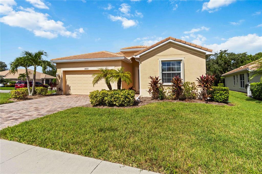 1480 Mossy Oak Drive North Port, FL 34287 - Photo 4 of 39 a front view of a house with garden