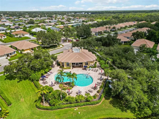 a view of a house with a big yard and potted plants