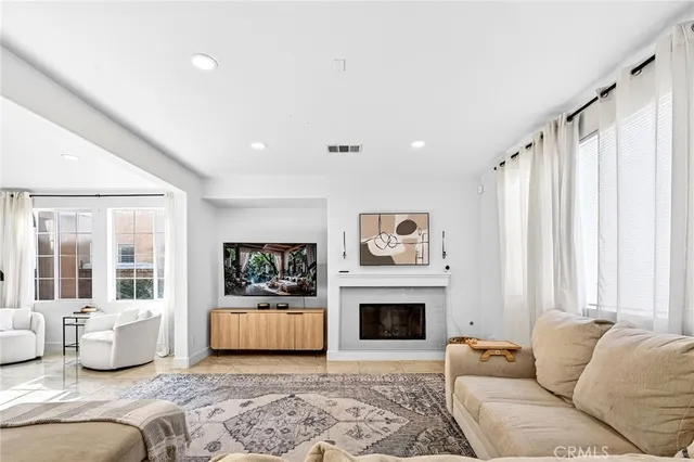 a living room with furniture a fireplace and a painting